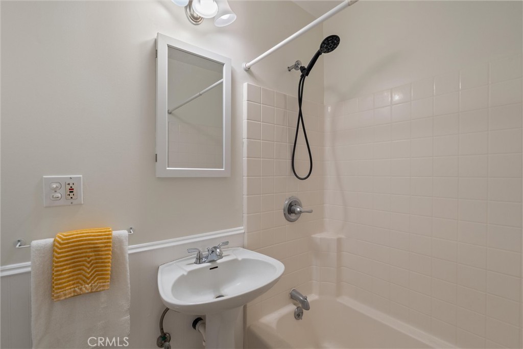 3426 Roxanne Avenue Long Beach, CA 90808 - Photo 16 of 21 a bathroom with a sink a mirror and a shower