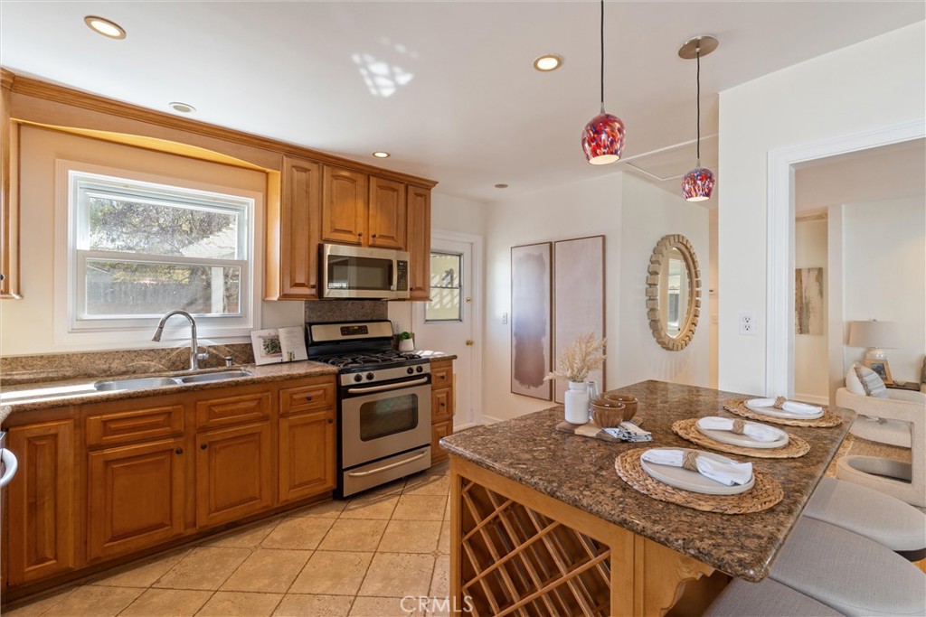3426 Roxanne Avenue Long Beach, CA 90808 - Photo 7 of 21 a kitchen with granite countertop stainless steel appliances a sink stove and microwave