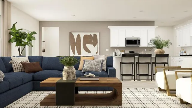 a living room with furniture potted plant and a table