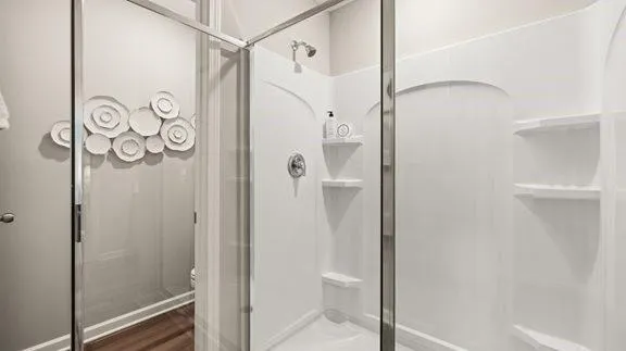 a bathroom with a shower and a glass door