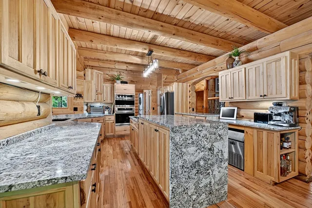a bathroom with a tub a sink and a large mirror