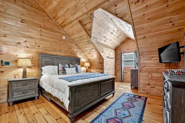 an aerial view of residential house with outdoor space and trees all around