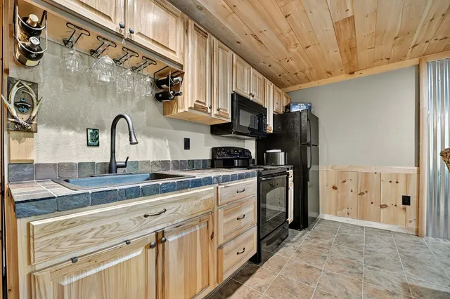 an aerial view of a house with a yard and trees all around