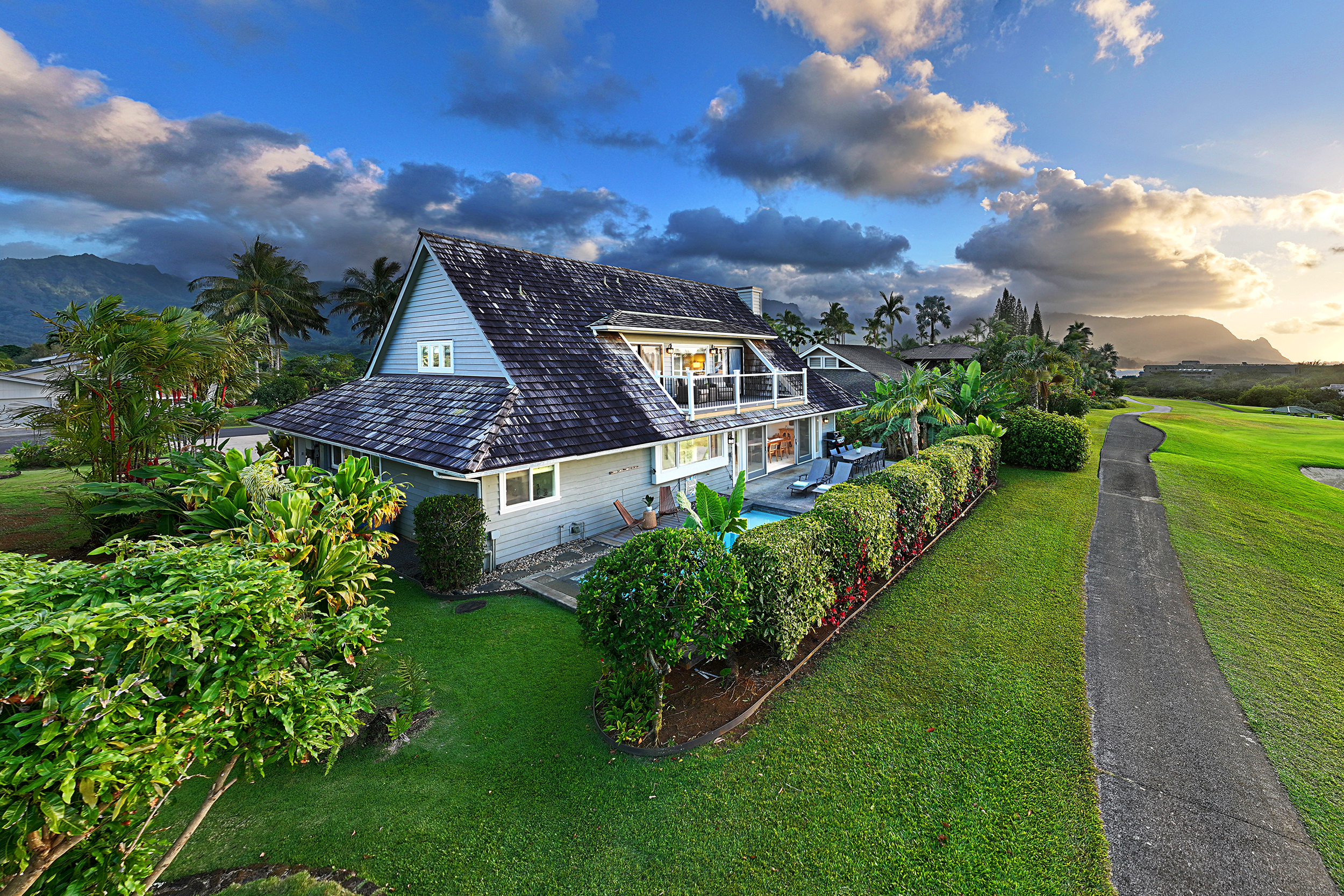 5348 Honoiki Road Princeville, HI 96722 - Photo 25 of 25 a view of a house with a big yard and potted plants