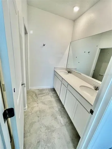a room with a sink and a mirror