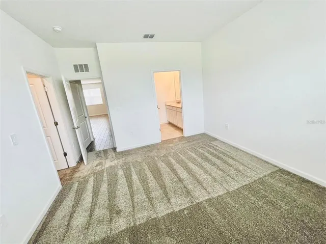 an empty room with a empty space and windows