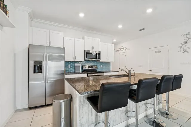 a kitchen with granite countertop a sink and a counter top space