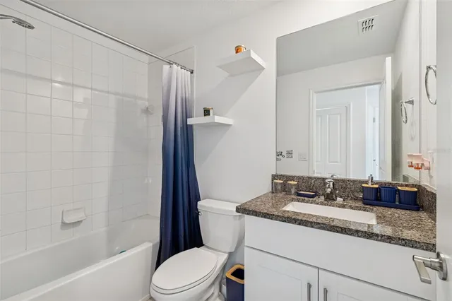 a spacious bathroom with double sink and a mirror