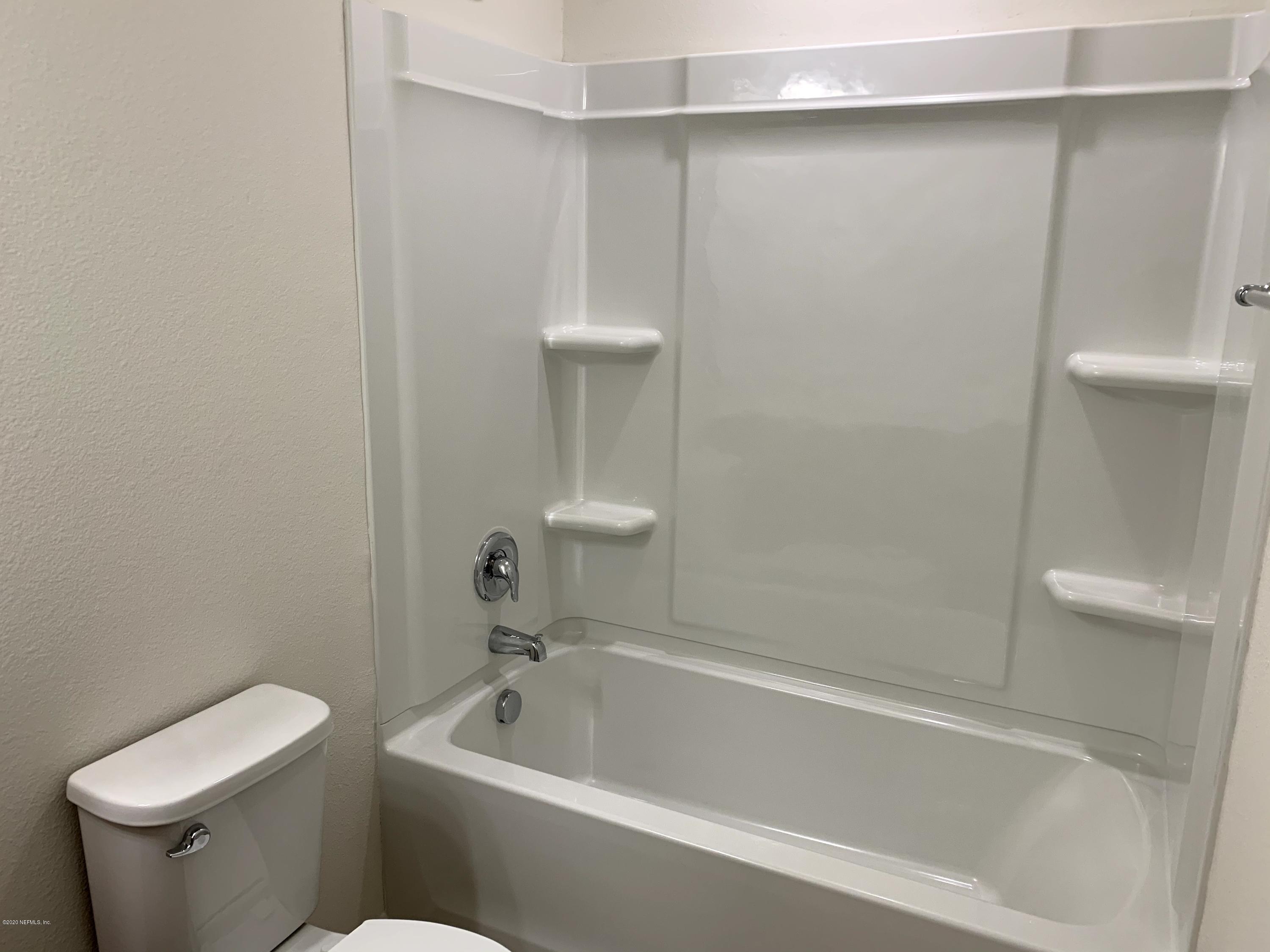 57 Bella Vita Way Ormond Beach, FL 32174 - Photo 14 of 16 a white bath tub sitting next to a toilet