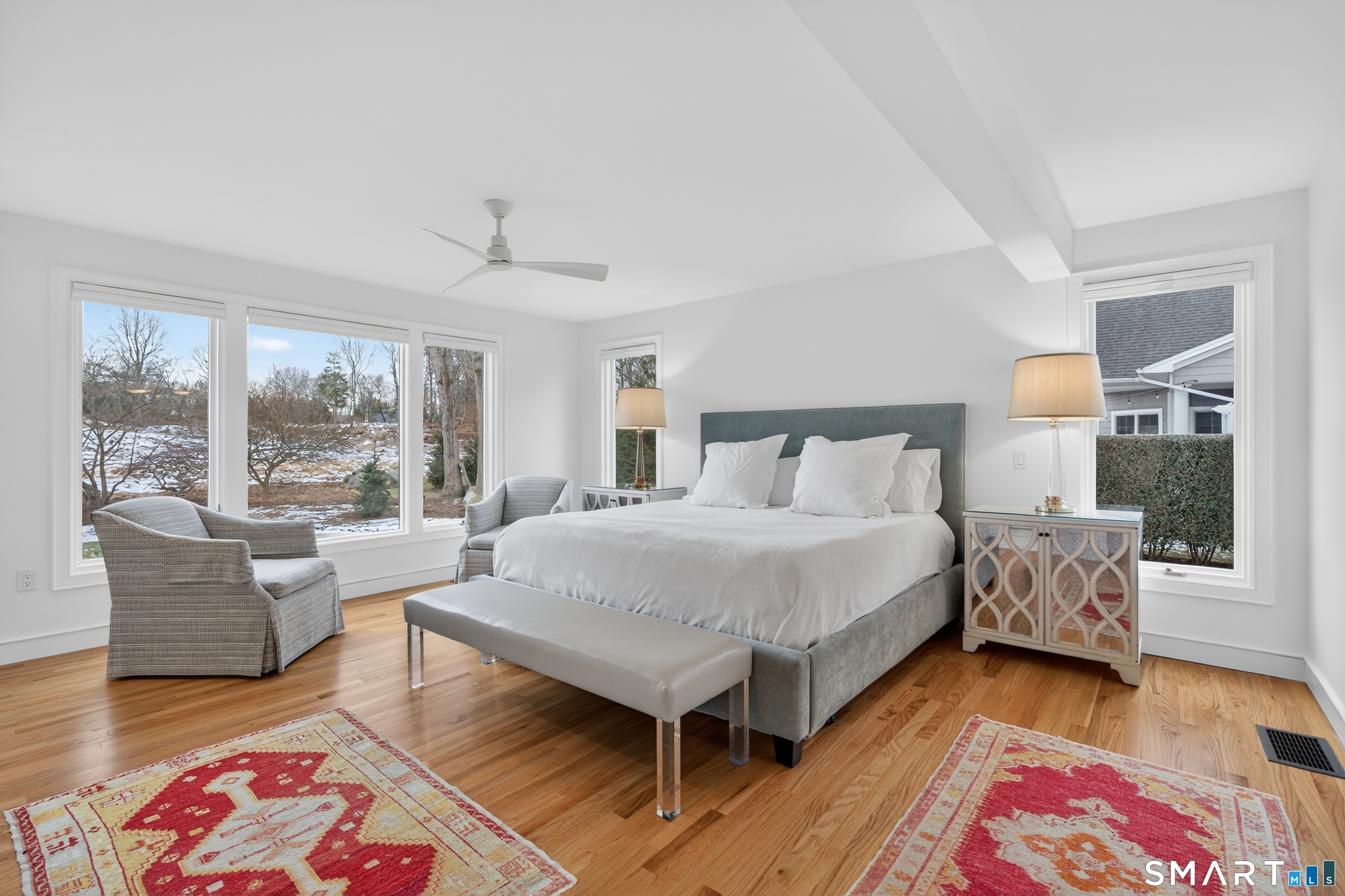 83 Old North Road Mystic, CT 06355 - Photo 13 of 40 a spacious bedroom with a bed a table and a couch