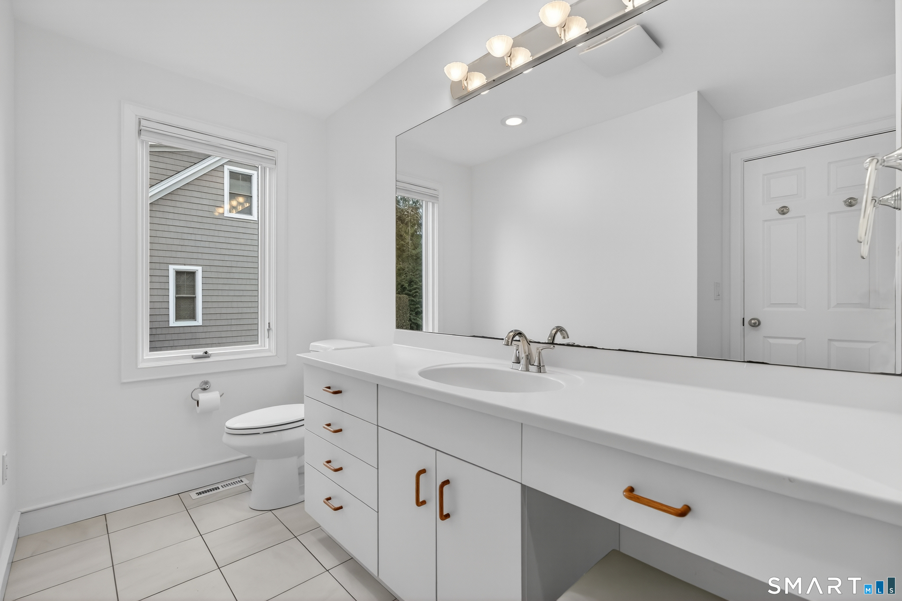 83 Old North Road Mystic, CT 06355 - Photo 17 of 40 a bathroom with a toilet sink and mirror