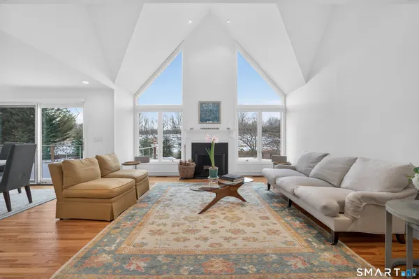 a living room with furniture large window and a fireplace