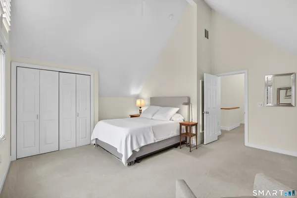 a bedroom with a bed and a closet