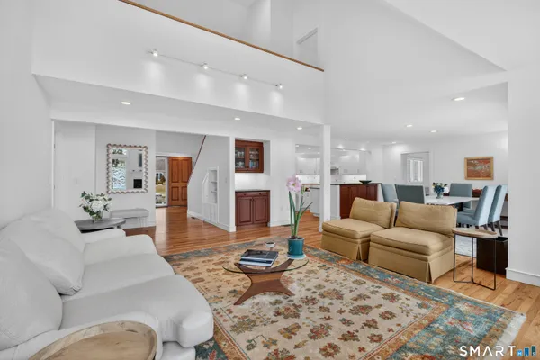 a living room with furniture wooden floor and a table