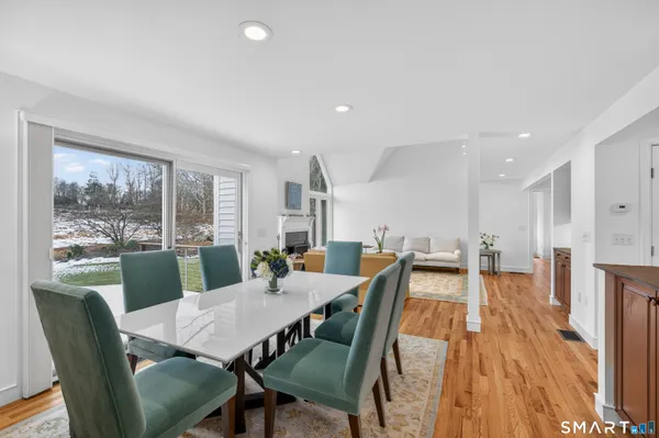 a view of a dining room with furniture window and wooden floor