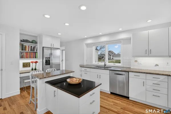 a kitchen with stainless steel appliances granite countertop a sink stove and cabinets