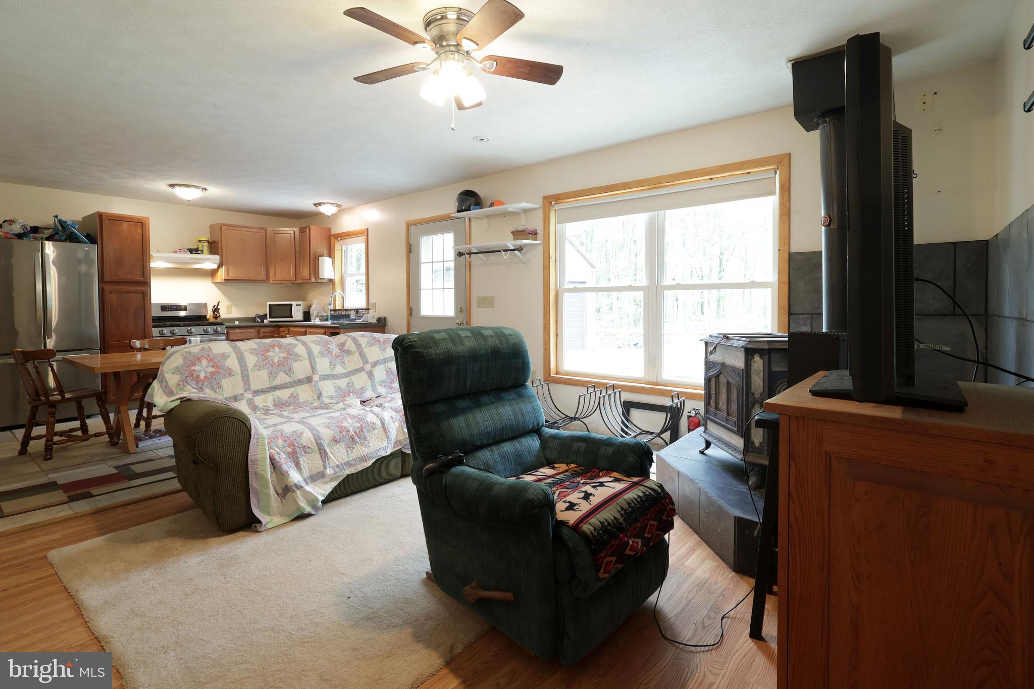358 Buckridge Road Howard, PA 16841 - Photo 7 of 40 a living room with furniture and a flat screen tv
