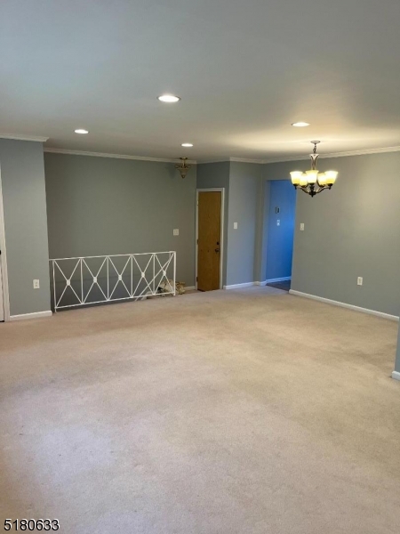 a view of an empty room with a chandelier
