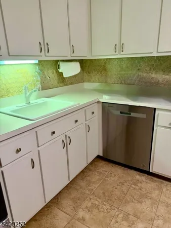 a kitchen with stainless steel appliances a stove a sink and a microwave