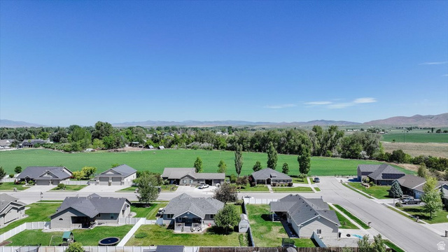 772 East 600 South Preston, ID 83263 - Photo 35 of 35 Expansive green spaces surround this residential street with multiple single-story homes featuring dark shingle roofs