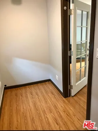 a view of a room with wooden floor and glass door