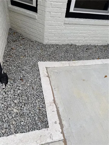 a large white kitchen with kitchen island a sink a stove a refrigerator and white cabinets