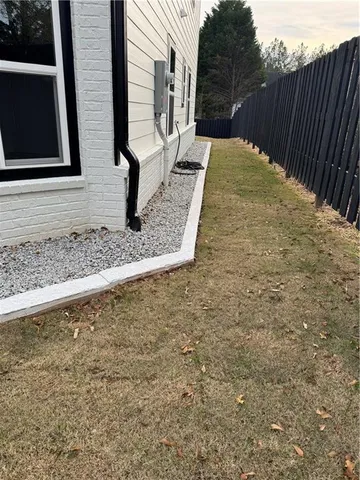 a living room with stainless steel appliances wooden floors