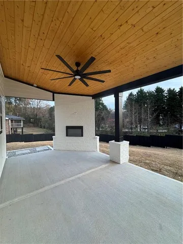 an empty room with wooden floor and entrance