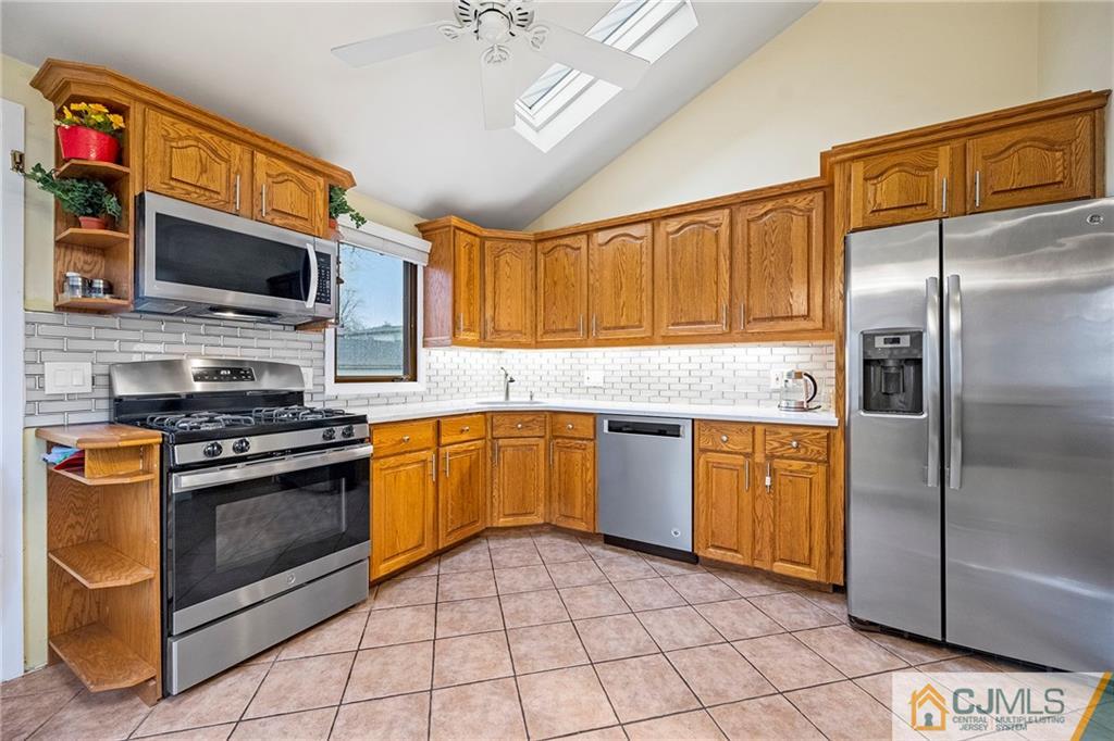 41 Ferris Road Edison, NJ 08817 - Photo 8 of 33 a kitchen with stainless steel appliances granite countertop a stove microwave and refrigerator