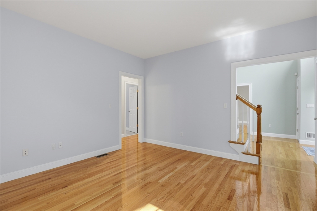 61 Indian Head Road Framingham, MA 01701 - Photo 20 of 42 a view of an empty room with wooden floor and a window