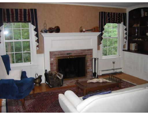 39 Wilson Pond Road Rowley, MA 01969 - Photo 7 of 15 a living room with a fireplace and a large window