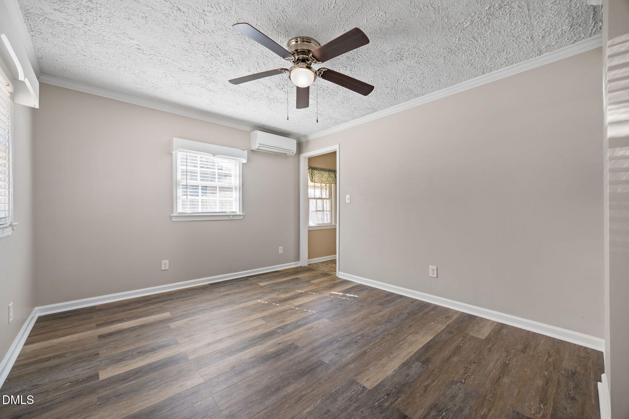 209 Weston Road Garner, NC 27529 - Photo 19 of 37 an empty room with wooden floor ceiling fan and windows