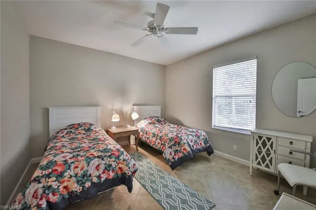 a bedroom with two beds and a window