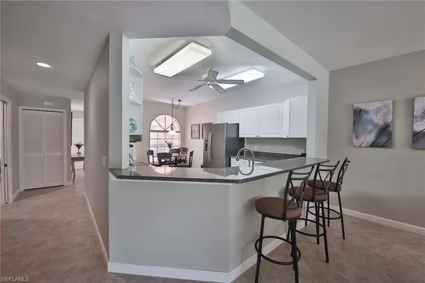 a view of a dining room with furniture and a chandelier fan