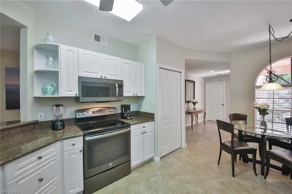 a kitchen with granite countertop a sink and appliances