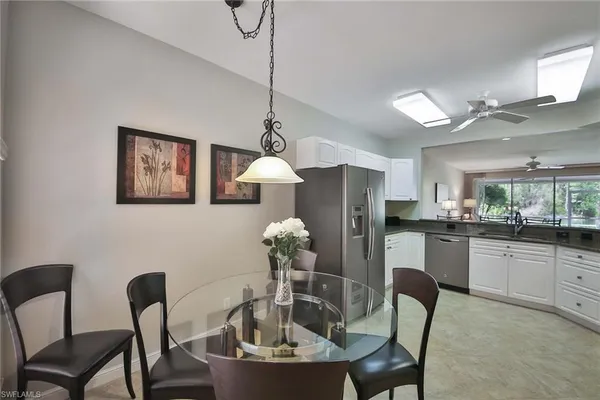 a dining room with furniture and chandelier