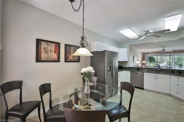 a dining room with furniture and chandelier