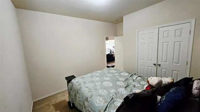 a bedroom with a bed and a tv