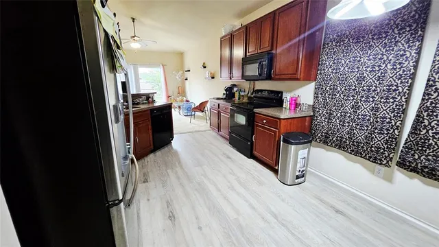 a kitchen with stainless steel appliances a refrigerator and a stove top oven