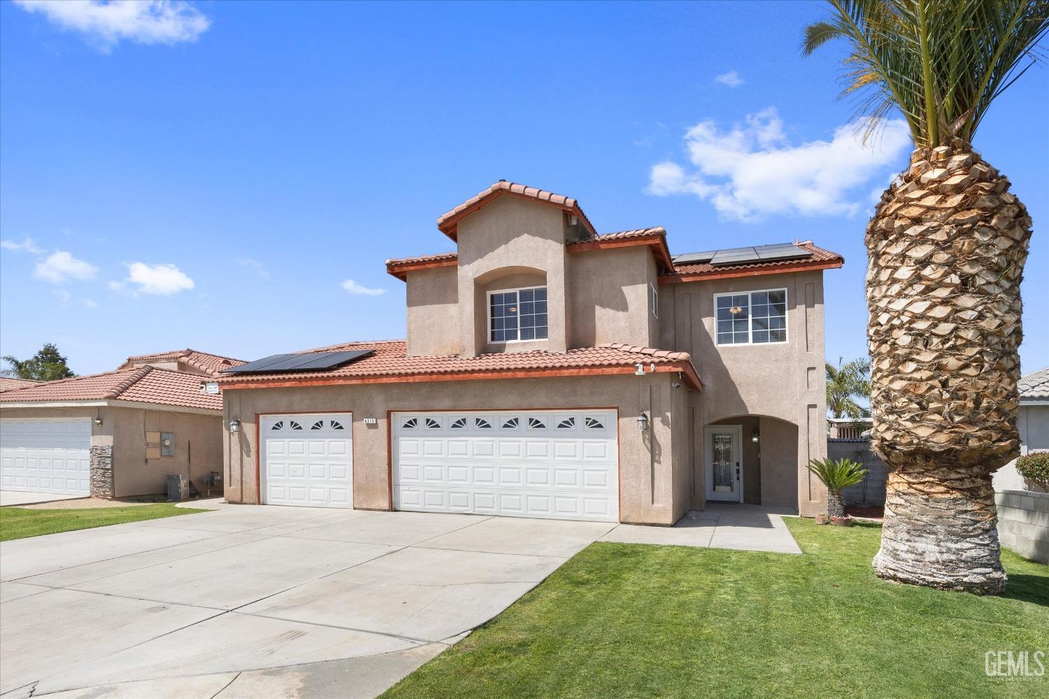 a front view of a house with a garden and yard