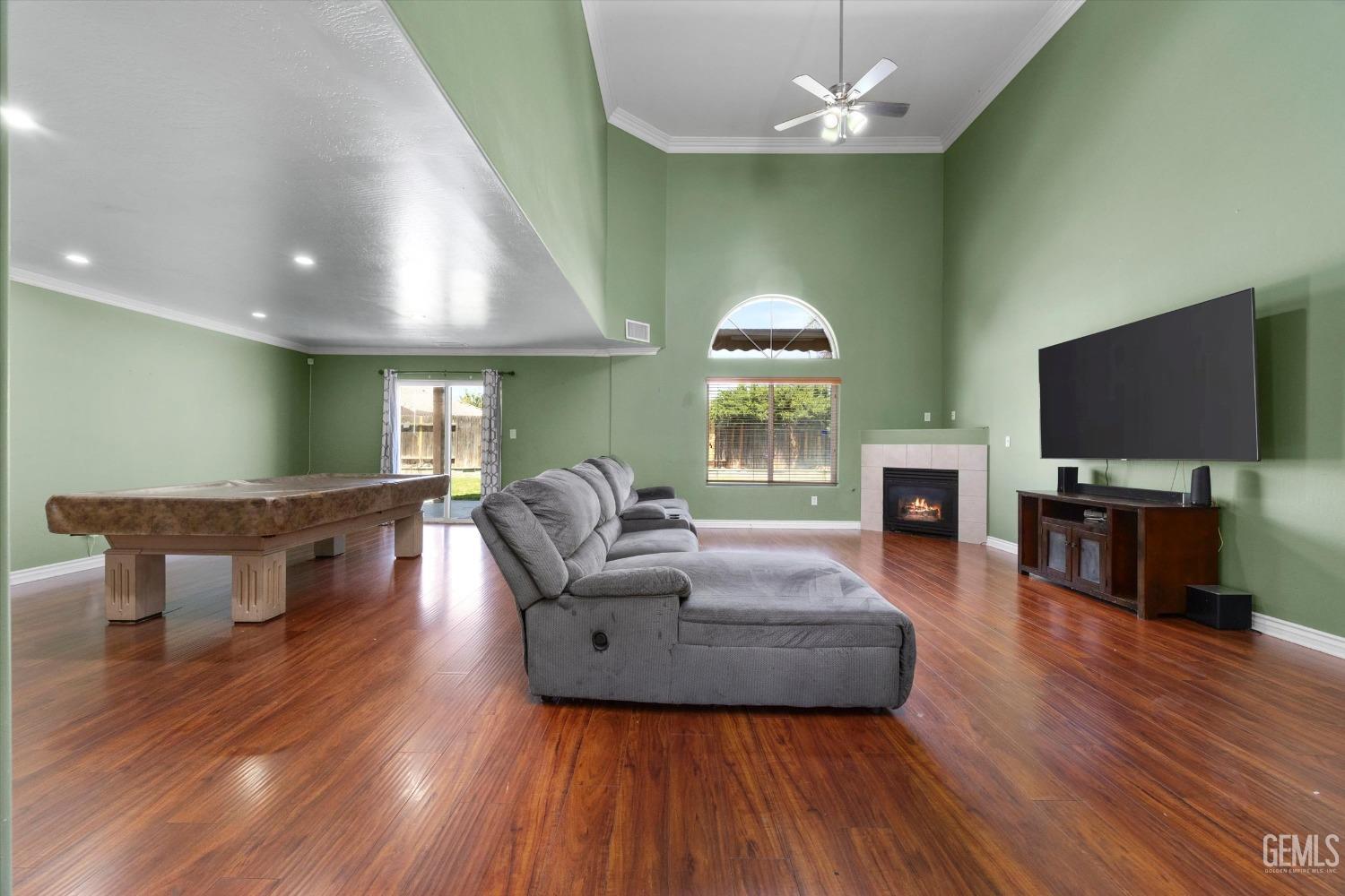 Undisclosed Address Bakersfield, CA 93313 - Photo 13 of 48 a living room with fireplace furniture and a flat screen tv