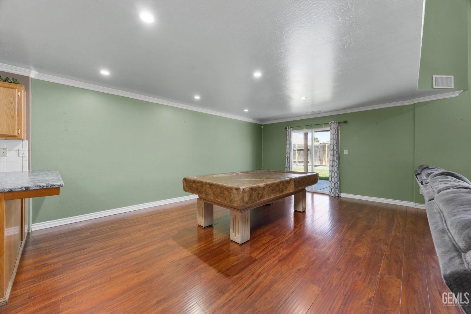Undisclosed Address Bakersfield, CA 93313 - Photo 20 of 48 a room with wooden floors and pool table