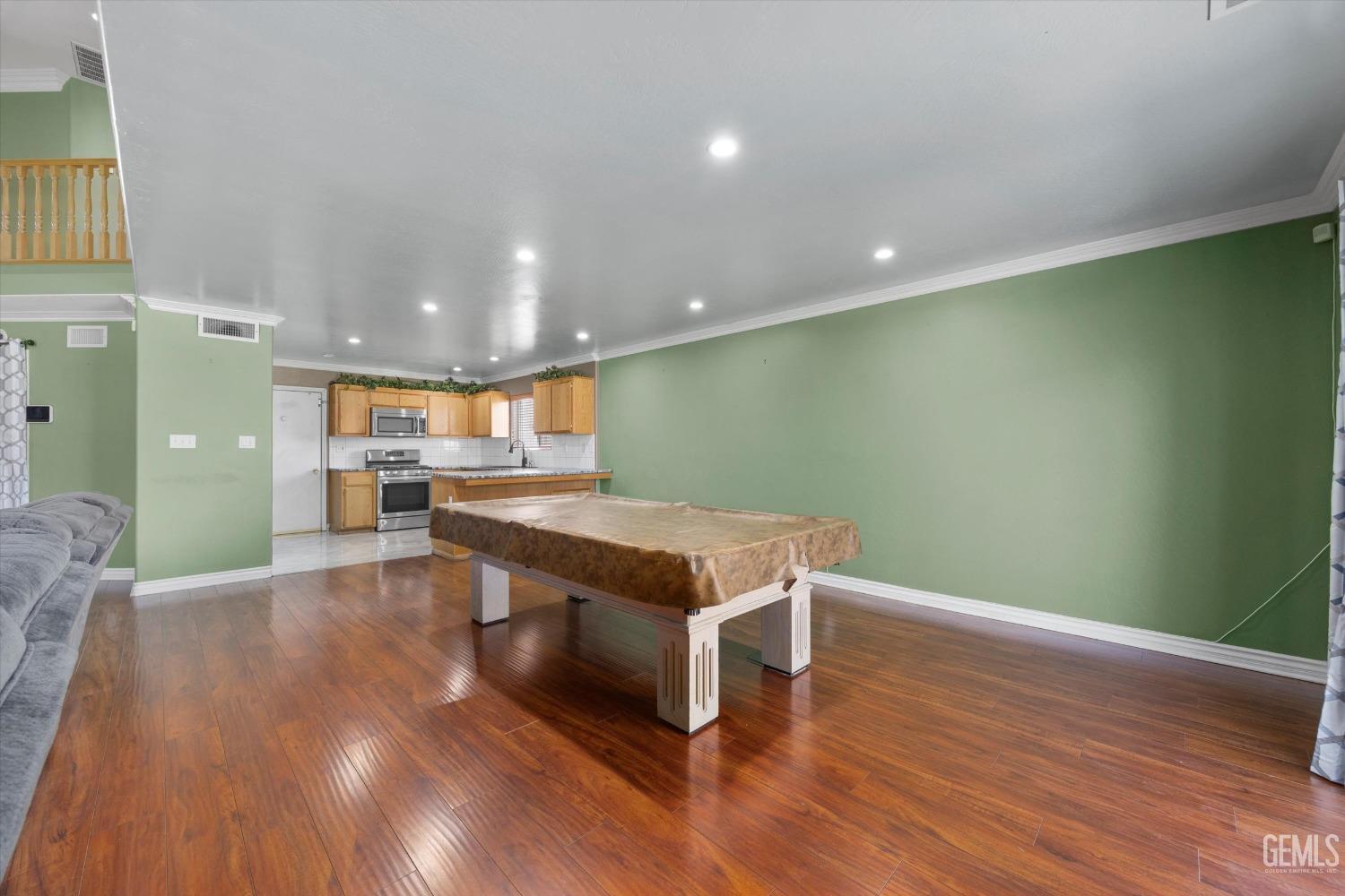 Undisclosed Address Bakersfield, CA 93313 - Photo 21 of 48 a room with wooden floors and pool view