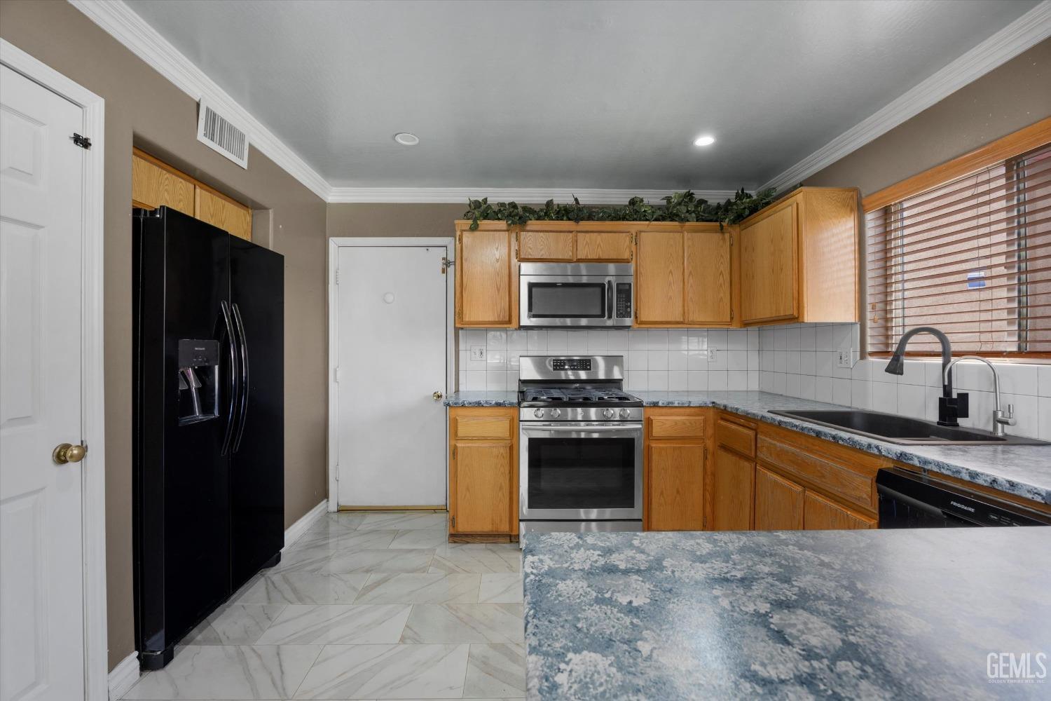 Undisclosed Address Bakersfield, CA 93313 - Photo 26 of 48 a kitchen with stainless steel appliances granite countertop a refrigerator stove top oven a sink and dishwasher