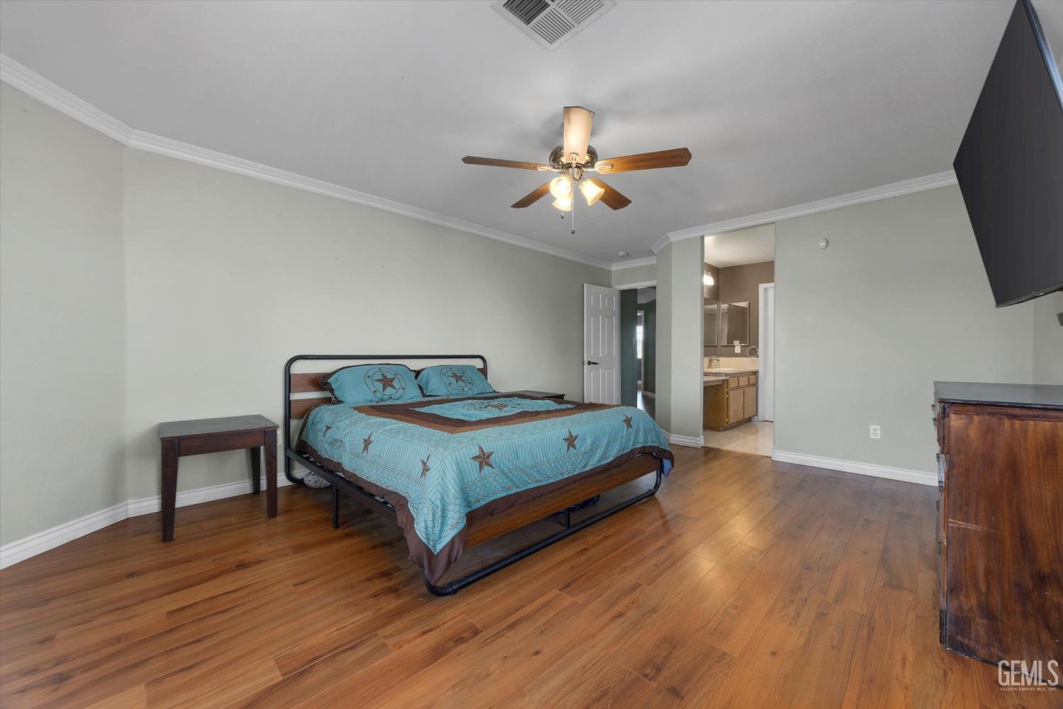 Undisclosed Address Bakersfield, CA 93313 - Photo 32 of 48 a bedroom with a bed and a chandelier