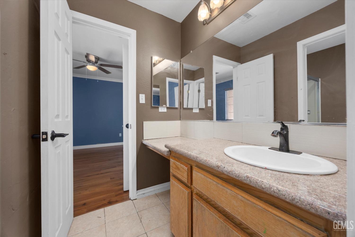 Undisclosed Address Bakersfield, CA 93313 - Photo 39 of 48 a bathroom with a granite countertop sink and a mirror