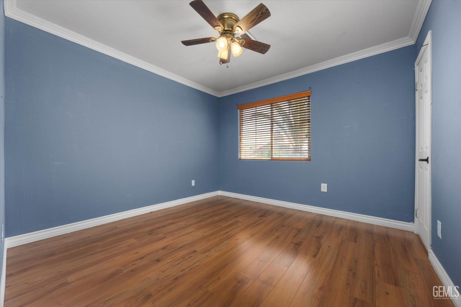 Undisclosed Address Bakersfield, CA 93313 - Photo 41 of 48 an empty room with wooden floor and windows