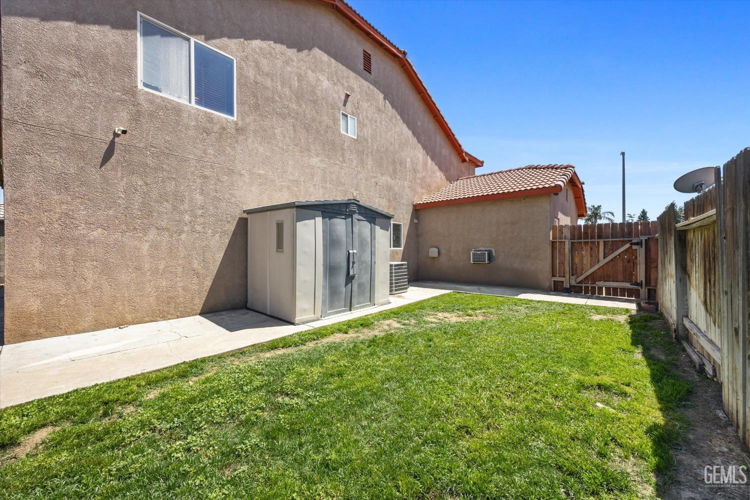 Undisclosed Address Bakersfield, CA 93313 - Photo 47 of 48 a backyard of a house with lots of green space