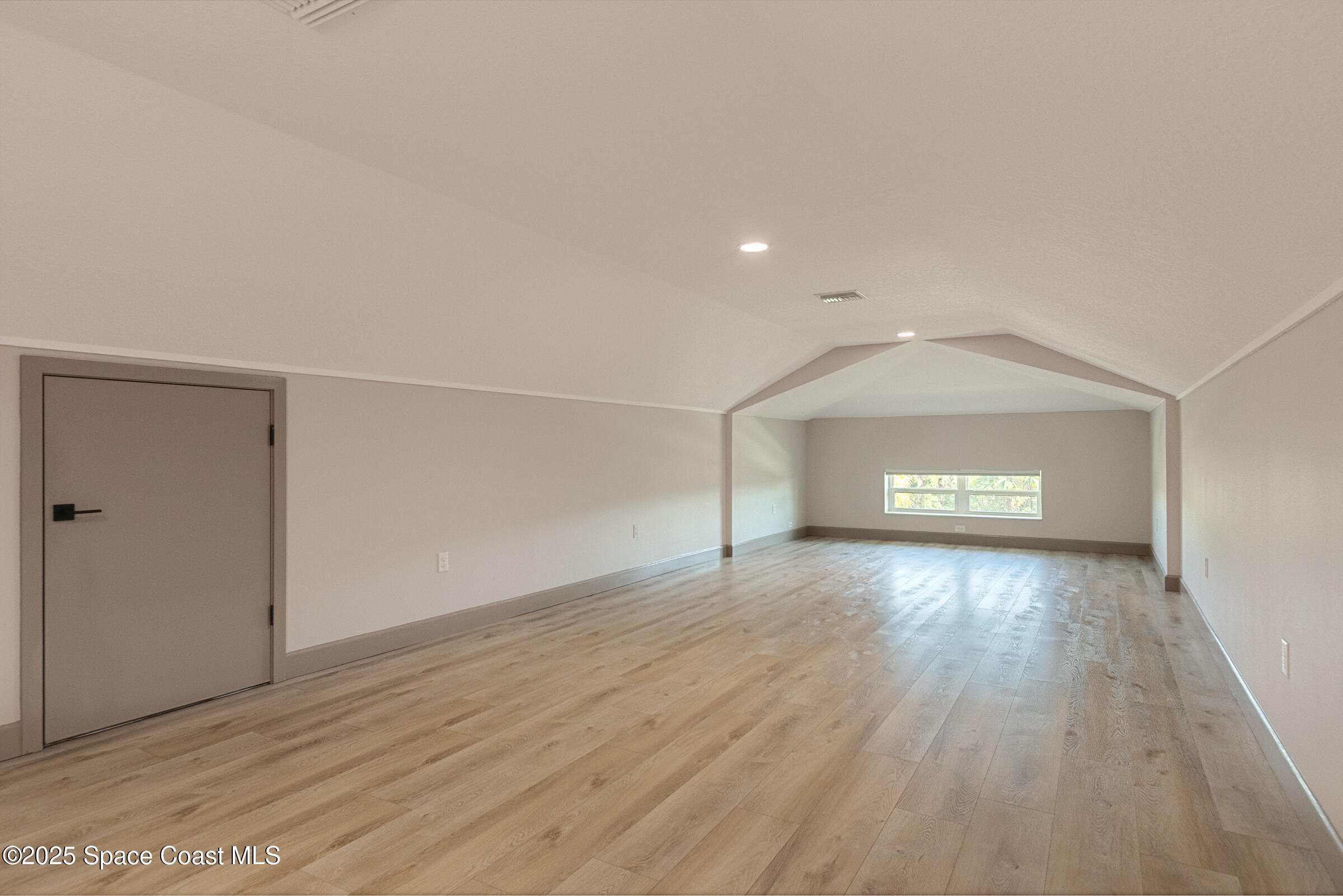 300 Pinto Lane Palm Bay, FL 32909 - Photo 31 of 70 a view of empty room with wooden floor and fireplace