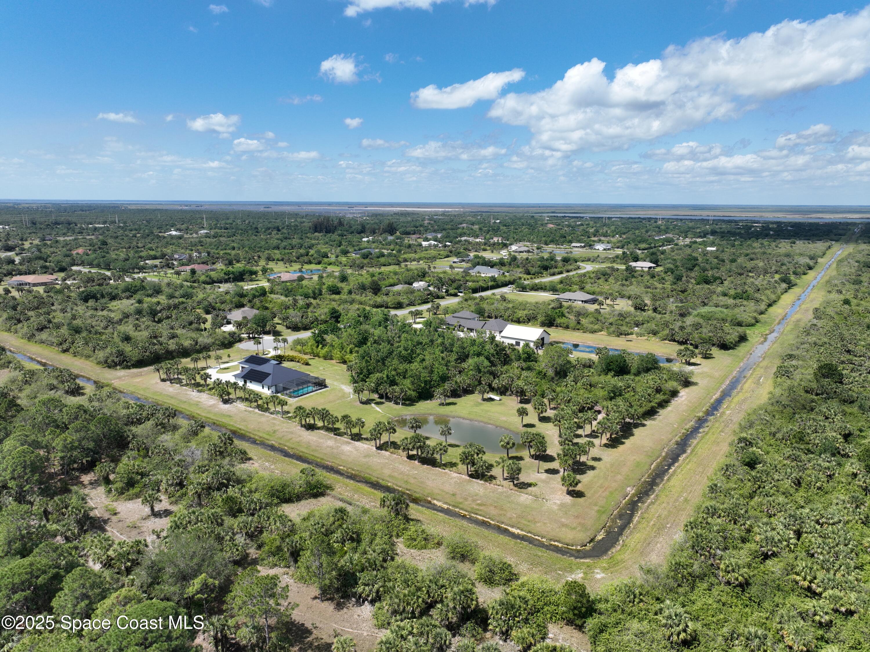300 Pinto Lane Palm Bay, FL 32909 - Photo 65 of 70 an aerial view of residential houses with outdoor space and trees